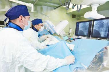 Surgeons team at vascular surgery operation clipart