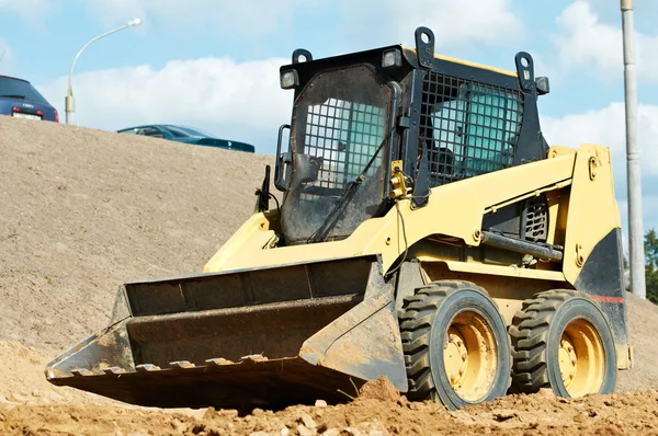 Skid steer loader at earth moving works — Stock Photo, Image