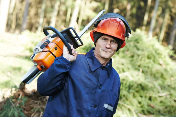 Lumberjack worker with chainsaw in the forest — Stock Photo, Image