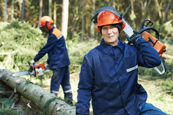 Lumberjack worker with chainsaw in the forest — Stock Photo, Image