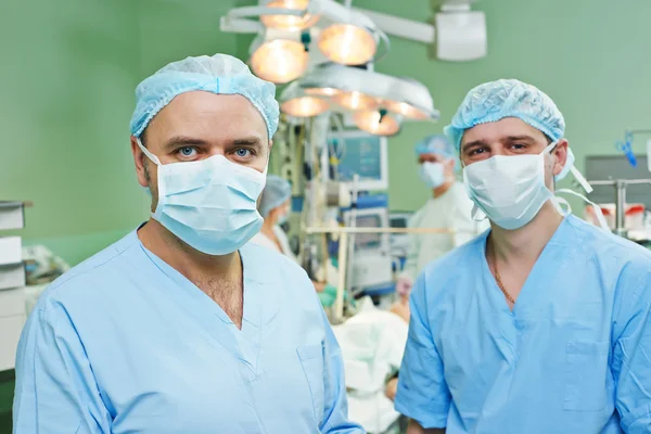 Smiling surgeons team at cardiac surgery operation — Stock Photo, Image