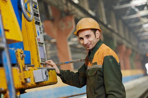 Industrial worker operating machine — Stock Photo, Image