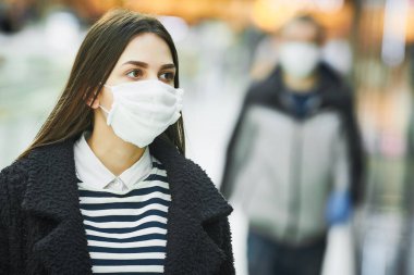 Kamuya açık bir yerde koruyucu maskeli bir kadın. corona virüsü salgını