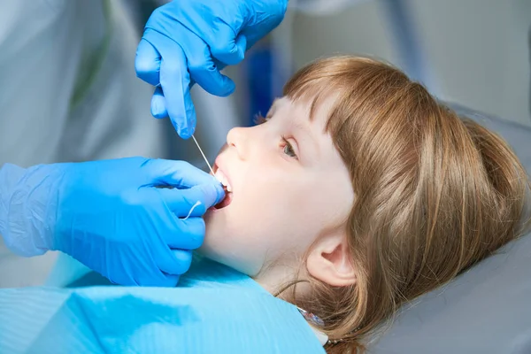 Odontología infantil. Liitle girl un examen de dentista, limpieza de dientes y tratamiento. —  Fotos de Stock