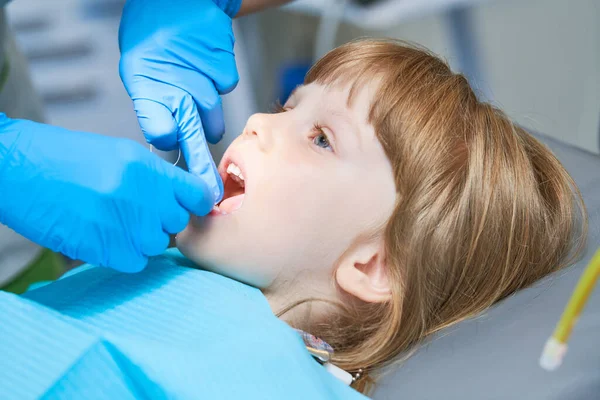 Kinderzahnheilkunde. Liitle Mädchen eine Zahnarztuntersuchung, Zahnreinigung und -behandlung. — Stockfoto