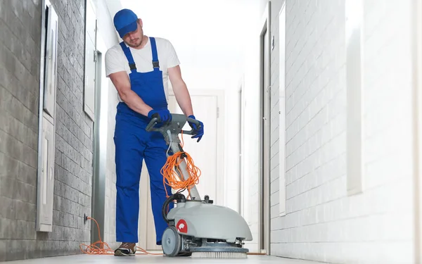 清洁服务 工人与机器清洗地板在大厅车库 — 图库照片