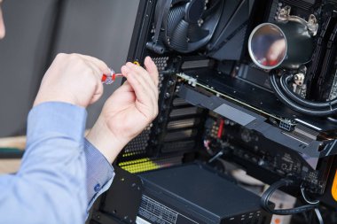 Bilgisayar montaj ya da onarım servisi. Bakım veya güncelleme sırasında grafik kartı yükleyen tamirci