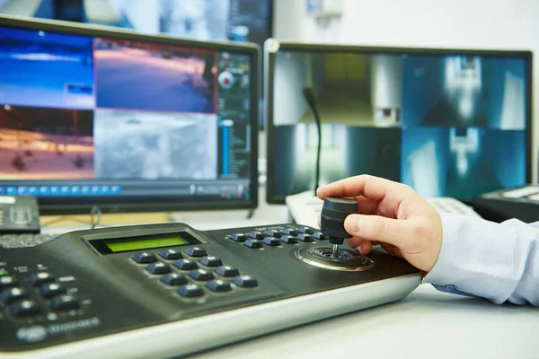 Güvenlik kamerası. Güvenlik görevlisi video izliyor ve izleme sistemi kullanıyor.