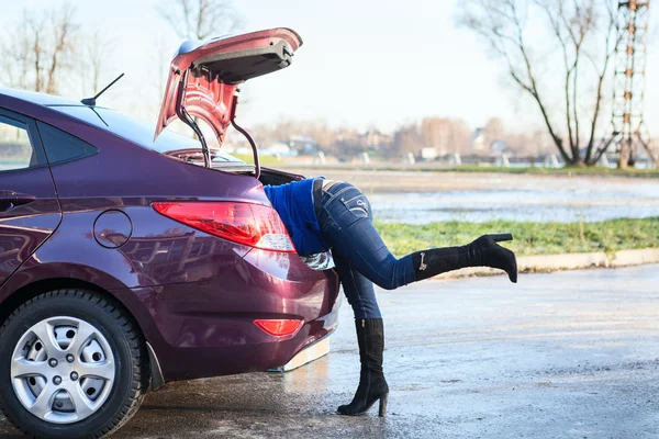 Woman's legs sticking out of a trunk — Stock Photo, Image