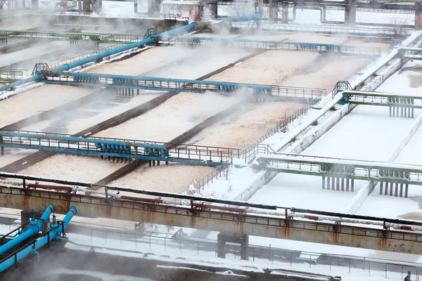 Depósitos de aguas residuales de aireación cubiertos de nieve en planta de tratamiento de aguas residuales — Foto de Stock