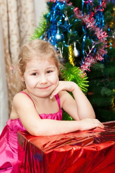 Klein meisje portret met giften in de buurt van de kerstboom Stockfoto