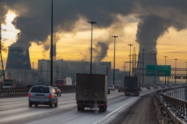SAINT-PETERSBURG City ringway with cars and air pollution from heat electric generation plant in Saint-Petersburg
