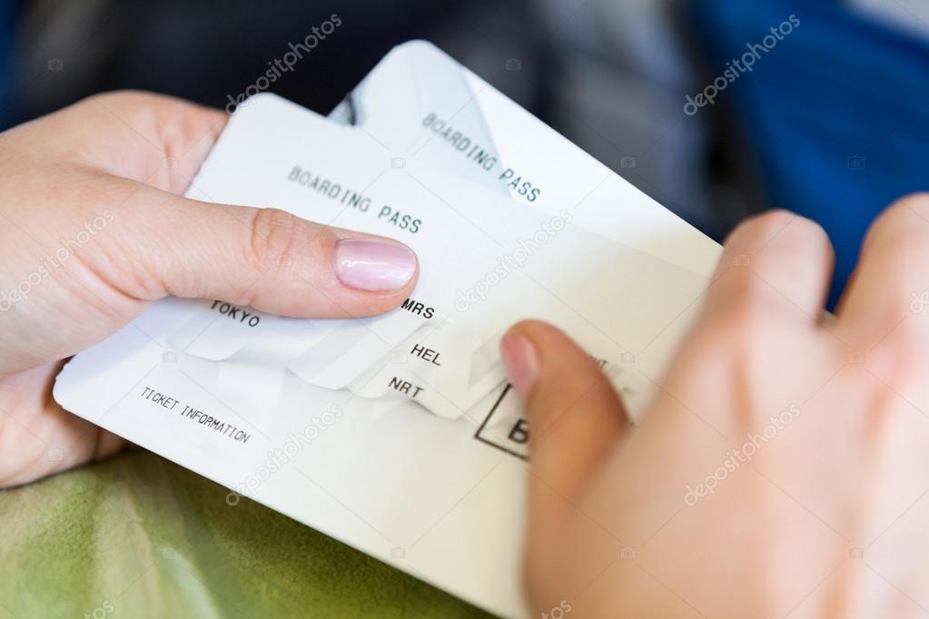 Close up view of Caucasian female hands with boarding passes