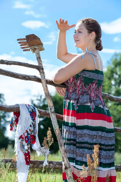 Mooie brunette ver weg op zoek in een veld — Stockfoto