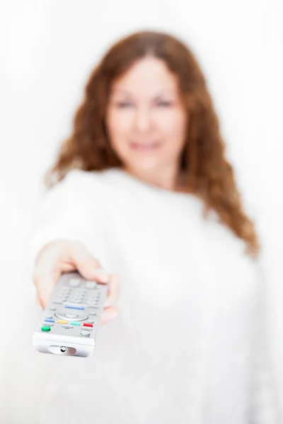 Defocused woman with Tv remote contro — Stock Photo, Image