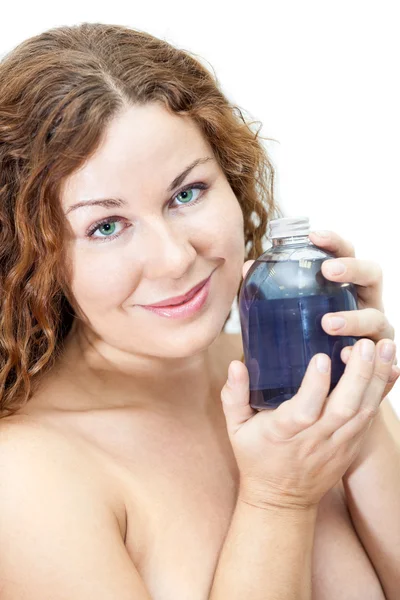 Naked woman with shampoo glass bottle in hands — Stock Photo, Image