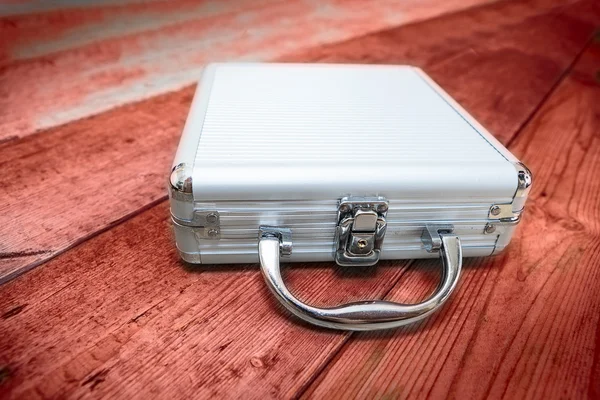 Steel briefcase on the red floor — Stock Photo, Image