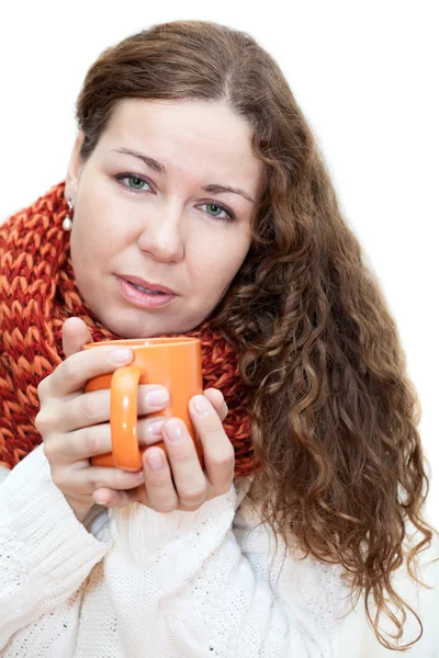 Young sick woman with a cup of tea in her hand — Stockfoto