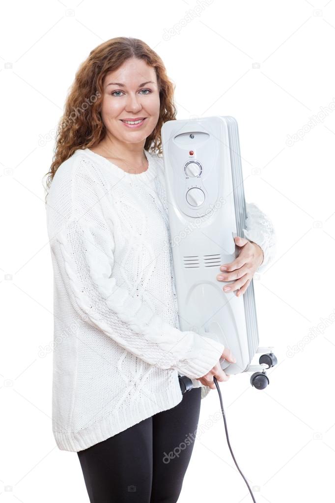 Woman and oil radiator in hands isolated on white background