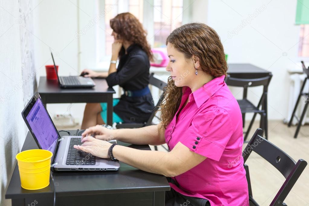 Women working with laptops