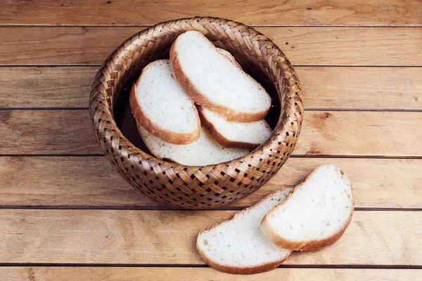 Slices of bread in wicker basket — Stock Photo, Image