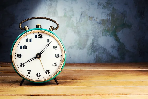 Retro alarm clock on wooden table — Stock Photo, Image