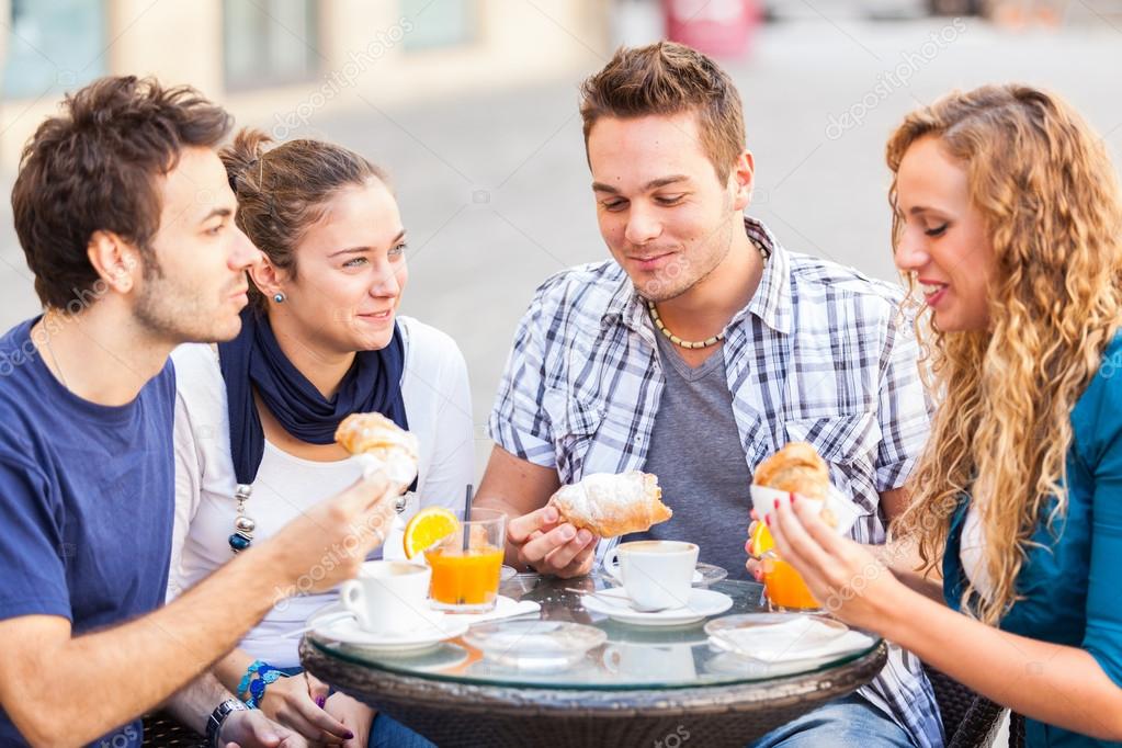 Happy Friends having a Traditional Italian Breakfast