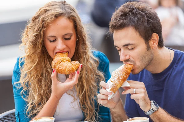 Giovane coppia avendo una colazione tradizionale italiana — Foto Stock