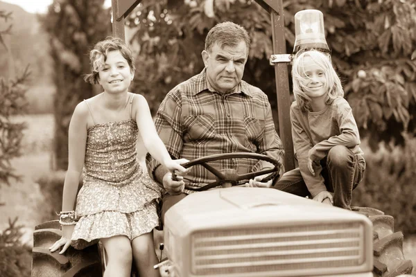 Adult Farmer with Children on Tractor — Stock Photo, Image