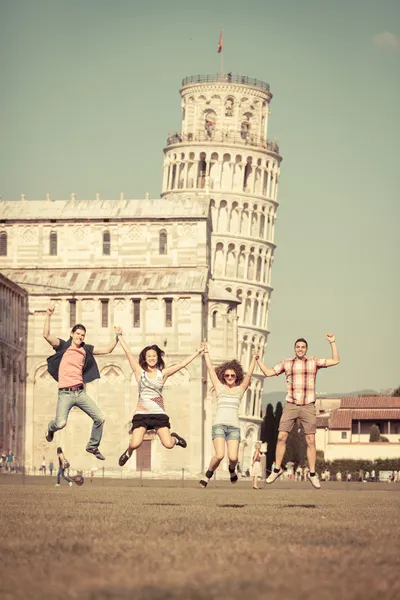 Group of Friends Jumping with Pisa Leaning Tower on Background — Stock Photo, Image