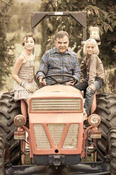 Adult Farmer with Children on Tractor — Stock Photo, Image