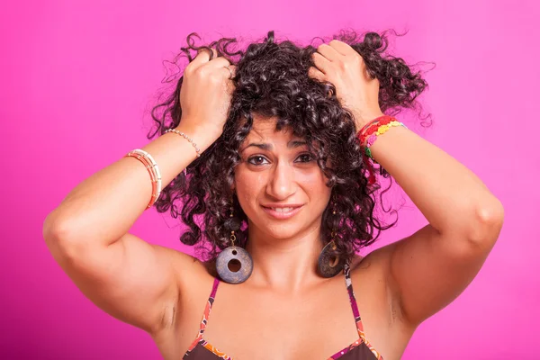 Jeune femme coupant ses cheveux bouclés — Photo