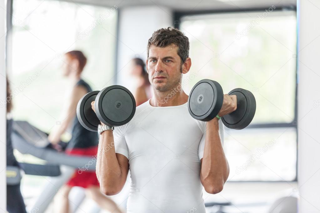 Man Lifting Weights at Gym