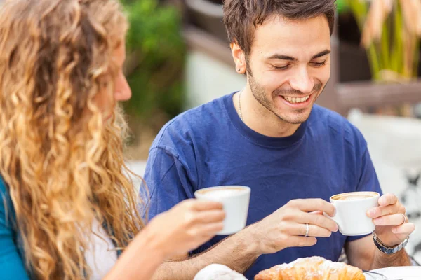 Pareja joven tomando un desayuno italiano tradicional —  Fotos de Stock