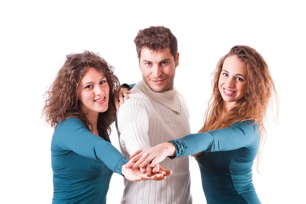 Drei glückliche Freunde mit Händen auf Stapel — Stockfoto