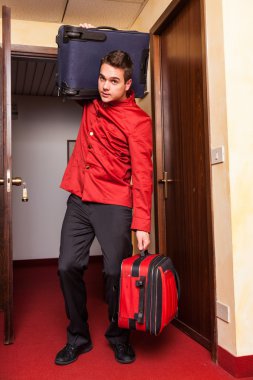 Tired Bellboy with Luggages clipart