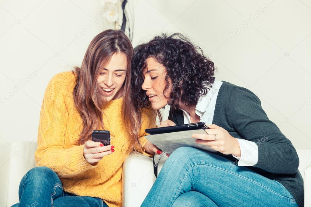Two Women with Technological Devices