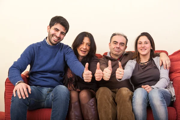 Happy Family on the Sofa with Thumbs Up — Stock Photo, Image