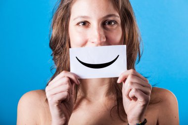 Young Woman with Smiley Emoticon on Blue Background