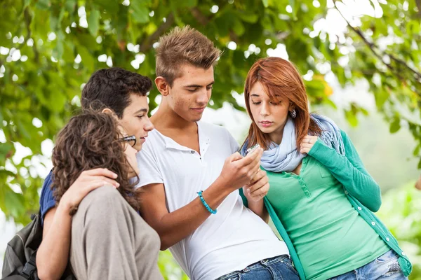 Group of Teenage Friends with Mobile Phone Royalty Free Stock Photos