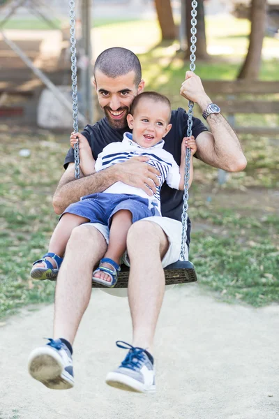 Little Boy Playing on the Swing with Father or Uncle — Stock Photo, Image
