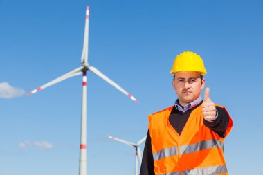 Technician Engineers Thumbs Up with Wind Power Generator clipart