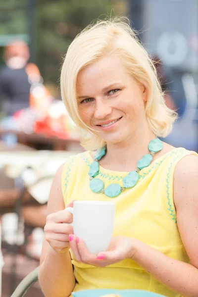 Mladá žena drží šálek kávy — Stock fotografie