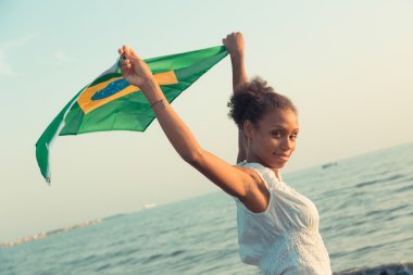Brazilian Girl with National Flag at Beach clipart