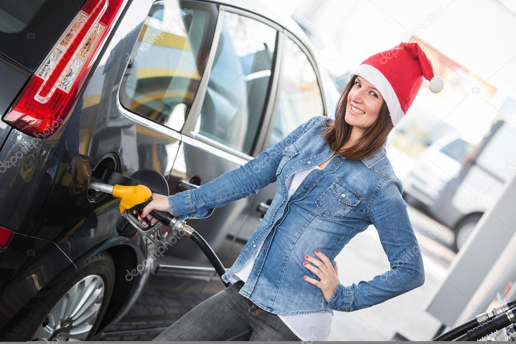 Young Woman with Santa Hat at Gas Station