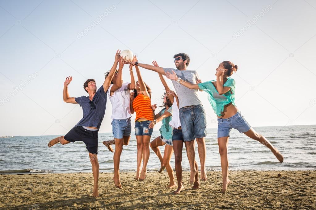 Group of Friends Playing with Ball at Beach
