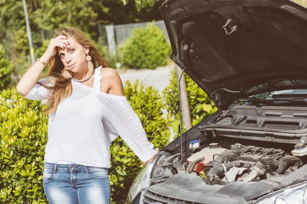 Mujer joven con coche dañado — Foto de Stock