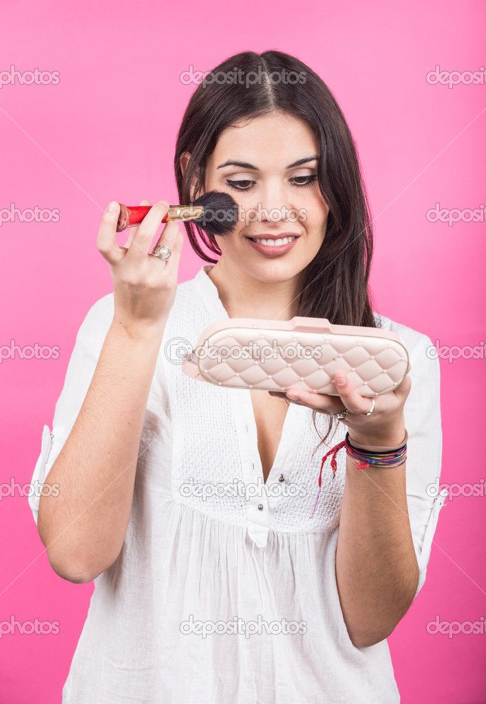 Young Woman Applying Make Up on her Face