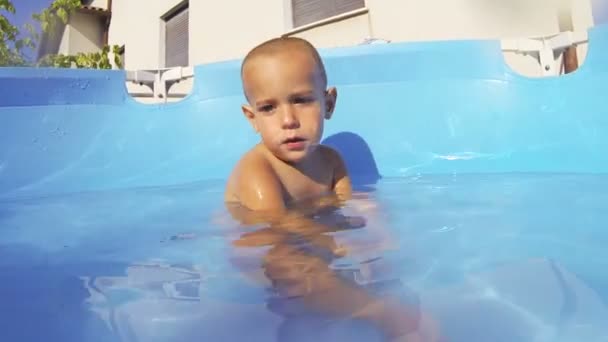 Kleines Kind spielt im Schwimmbad — Stockvideo