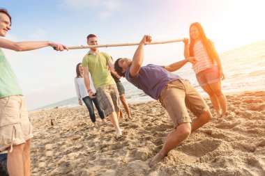 Friends Dancing Limbo at Beach clipart